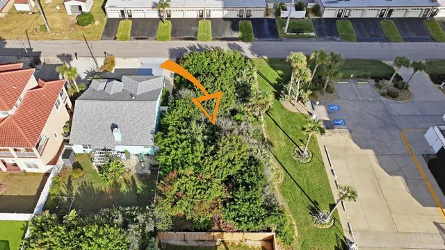 an aerial view of a residential houses with outdoor space