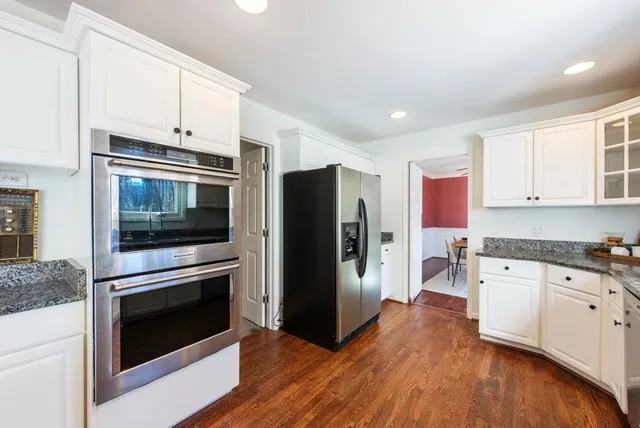 a kitchen with stainless steel appliances granite countertop a stove a sink and a refrigerator