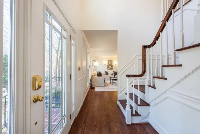 a very nice looking room with wooden floor and windows