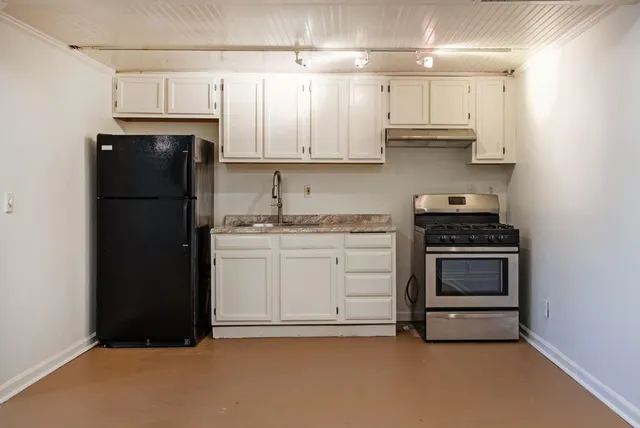 a sign that is sitting in front of flowers