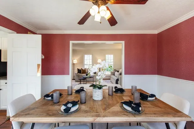 a living room with furniture fireplace and a large window