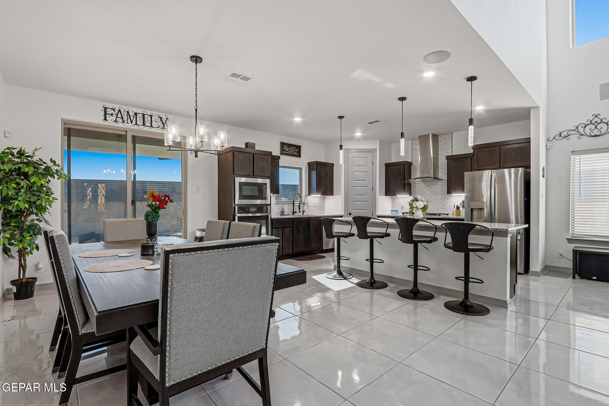 12892 Jonathan Raul El Paso, TX 79928 - Photo 19 of 53 a kitchen with stainless steel appliances kitchen island granite countertop a table chairs and a refrigerator