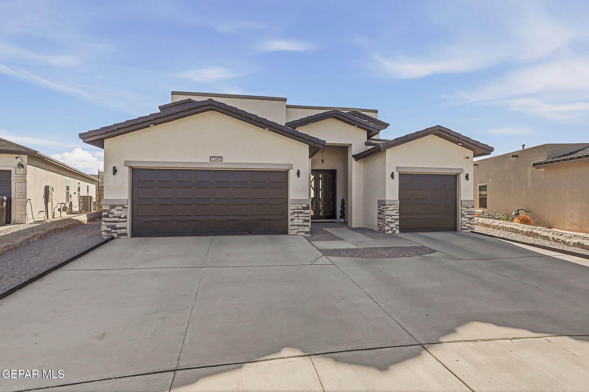 12892 Jonathan Raul El Paso, TX 79928 - Photo 2 of 53 a front view of a house with a garage and a garage