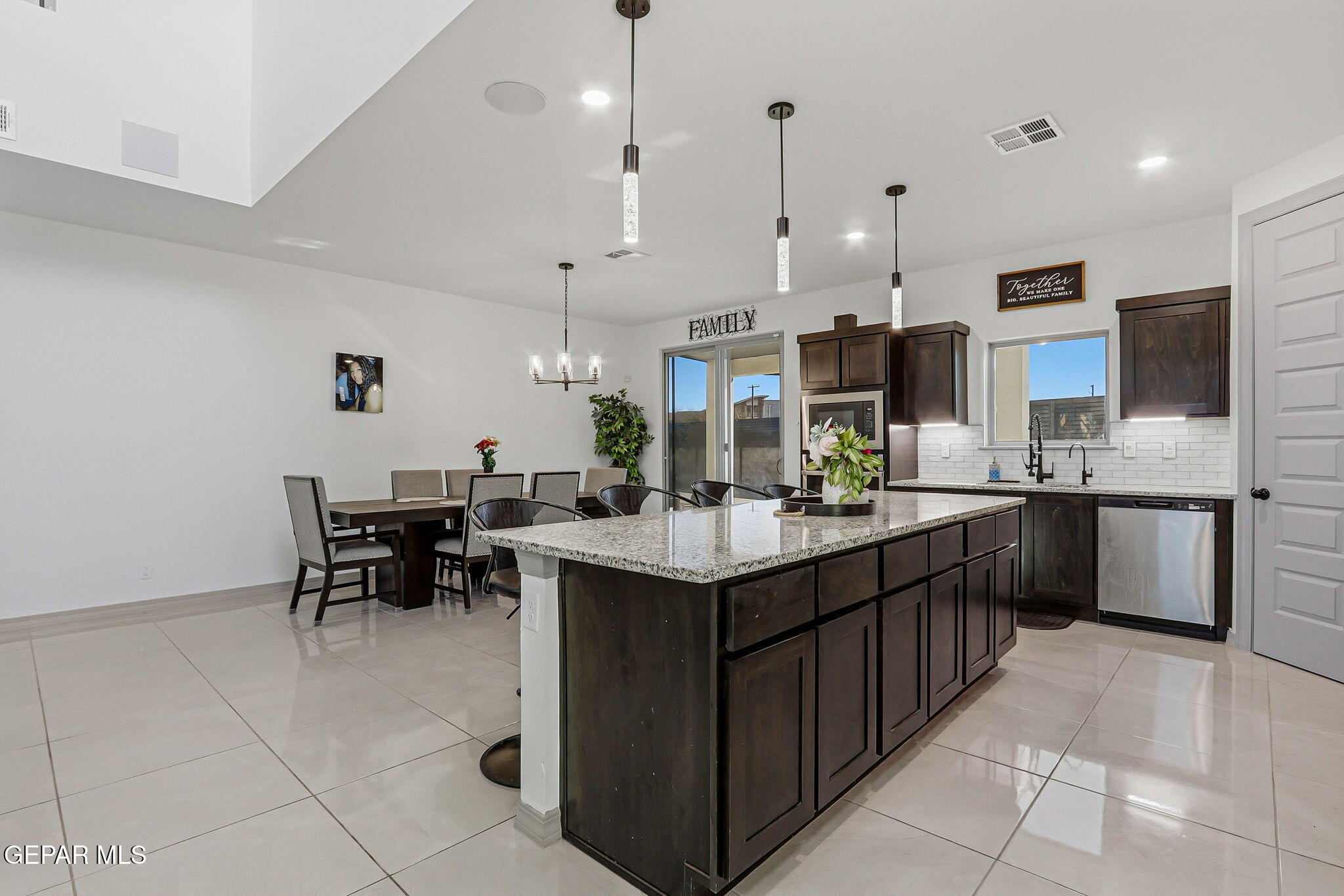 12892 Jonathan Raul El Paso, TX 79928 - Photo 22 of 53 a kitchen with kitchen island granite countertop a sink counter and chairs