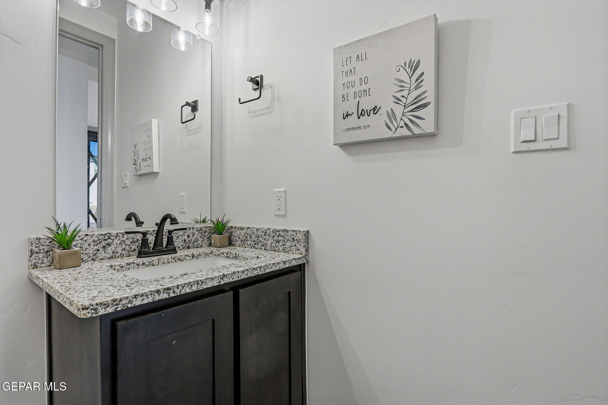 12892 Jonathan Raul El Paso, TX 79928 - Photo 30 of 53 a bathroom with a granite countertop sink and a mirror