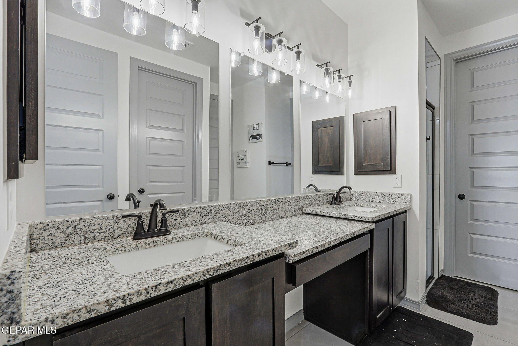 12892 Jonathan Raul El Paso, TX 79928 - Photo 33 of 53 a bathroom with a granite countertop sink and a mirror