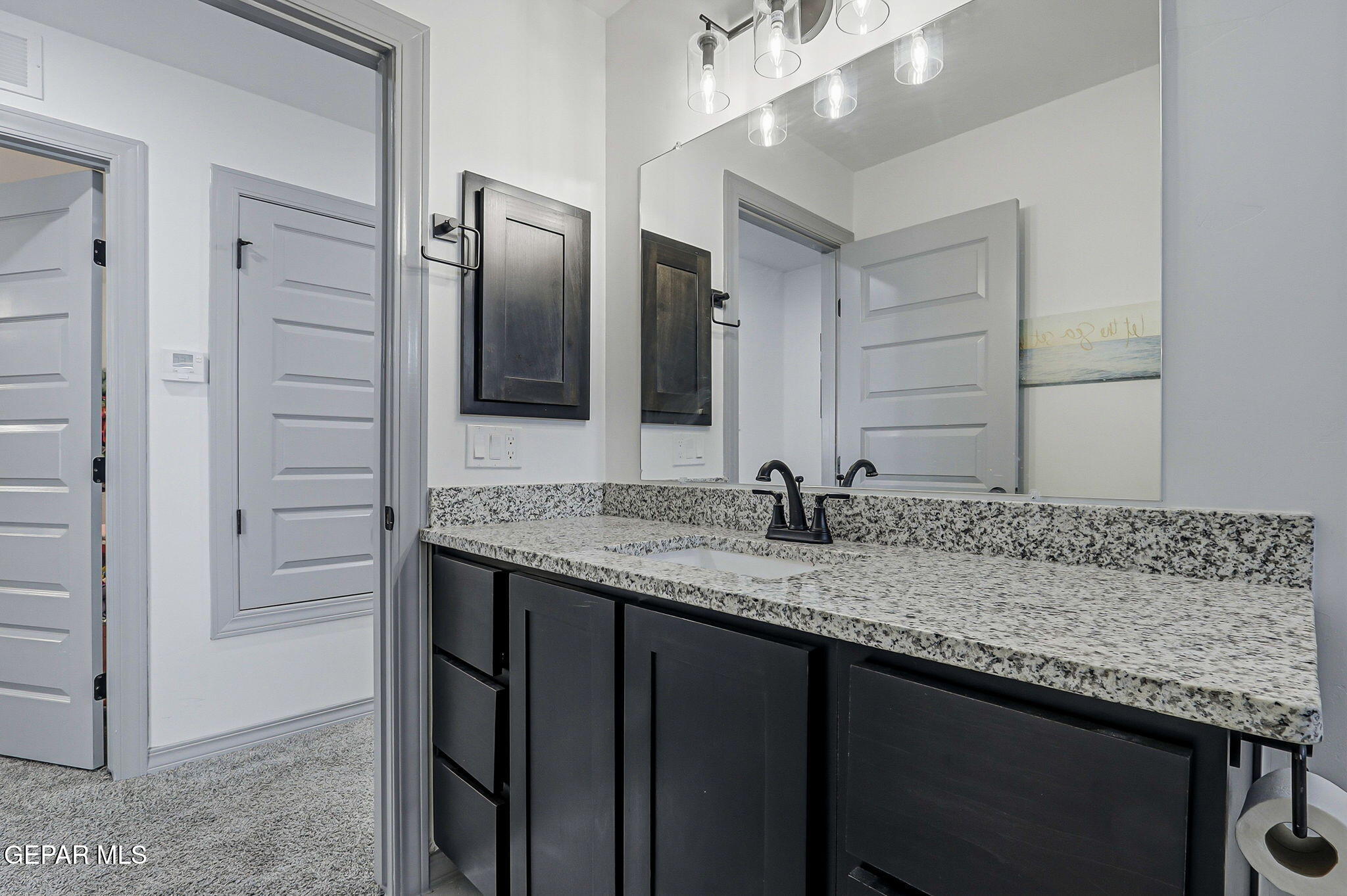 12892 Jonathan Raul El Paso, TX 79928 - Photo 46 of 53 a bathroom with a granite countertop sink and a mirror