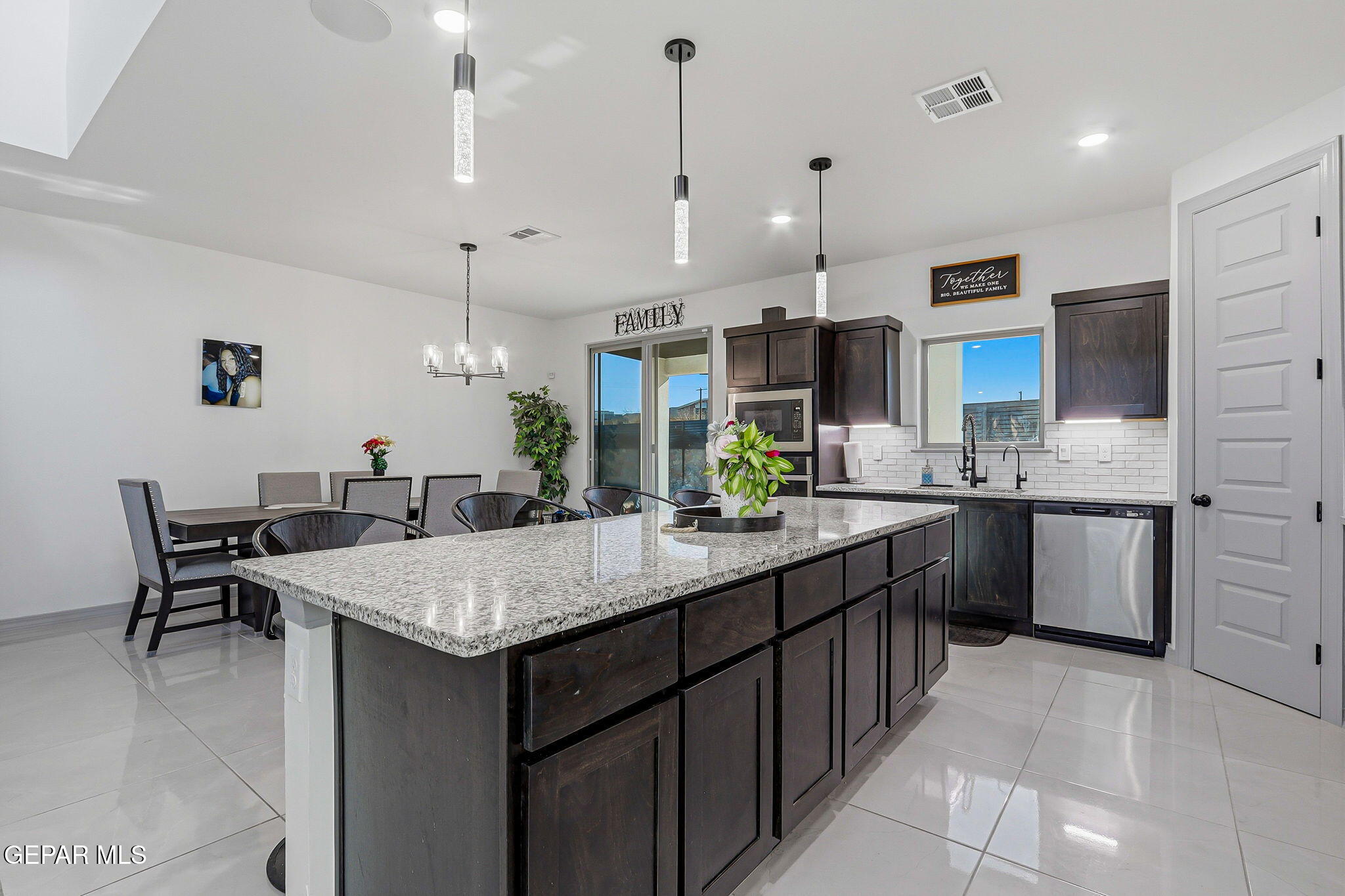 12892 Jonathan Raul El Paso, TX 79928 - Photo 8 of 53 a kitchen with kitchen island granite countertop a sink counter and chairs