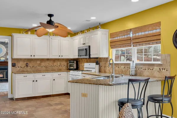 a kitchen with granite countertop a sink and a window