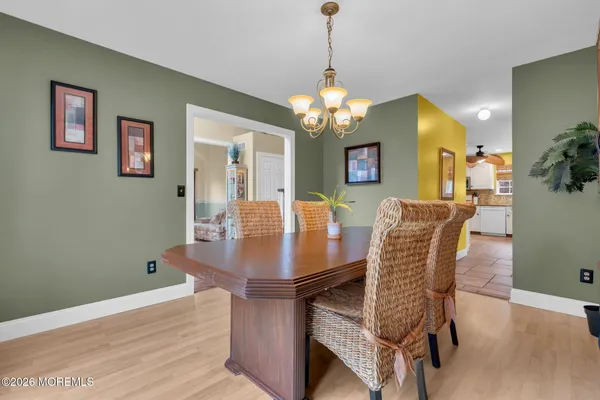 a view of a dining room with furniture and chandelier