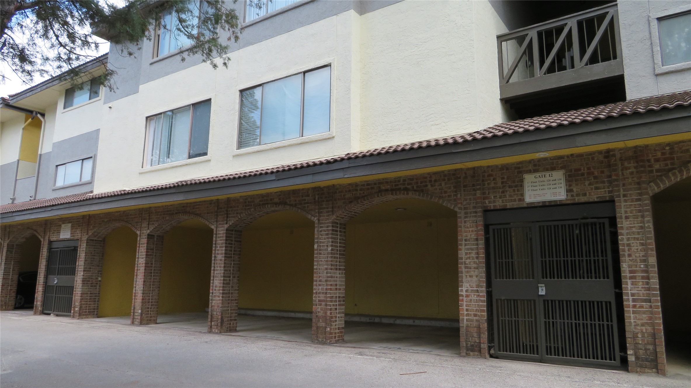 806 West 24th Street, Unit 200 Austin, TX 78705 - Photo 25 of 33 Ground-level parking with brick archways offers convenience and classic architectural appeal.
