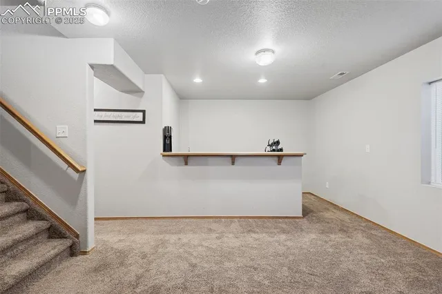 a kitchen with a sink a stove and chairs
