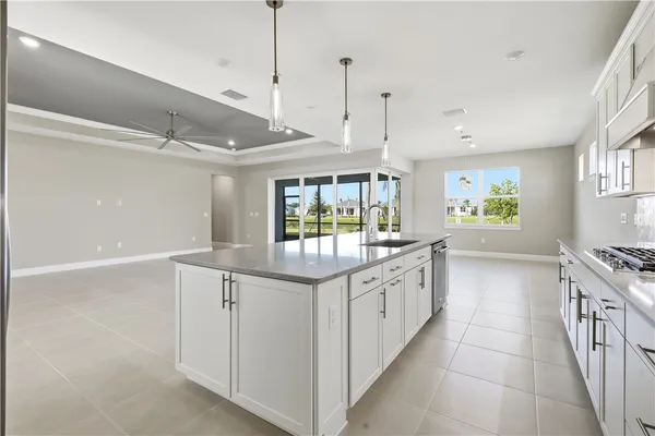 a kitchen with granite countertop a sink and a wooden floor