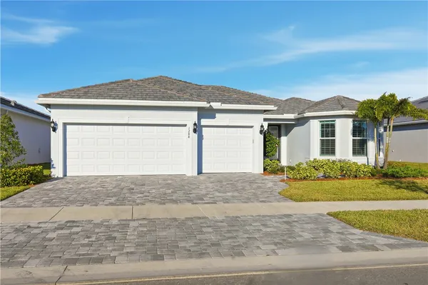 a front view of a house with a yard and garage