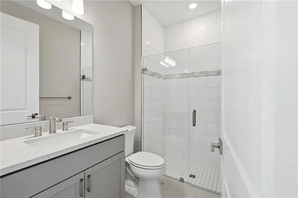 a bathroom with a sink toilet and shower