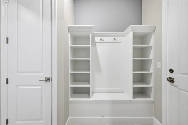 a view of walk in closet with empty racks