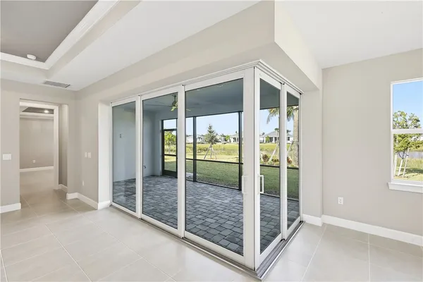 en empty room with sliding glass door and mountain view