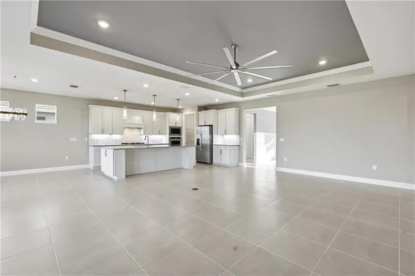 a view of a kitchen with a sink and a refrigerator