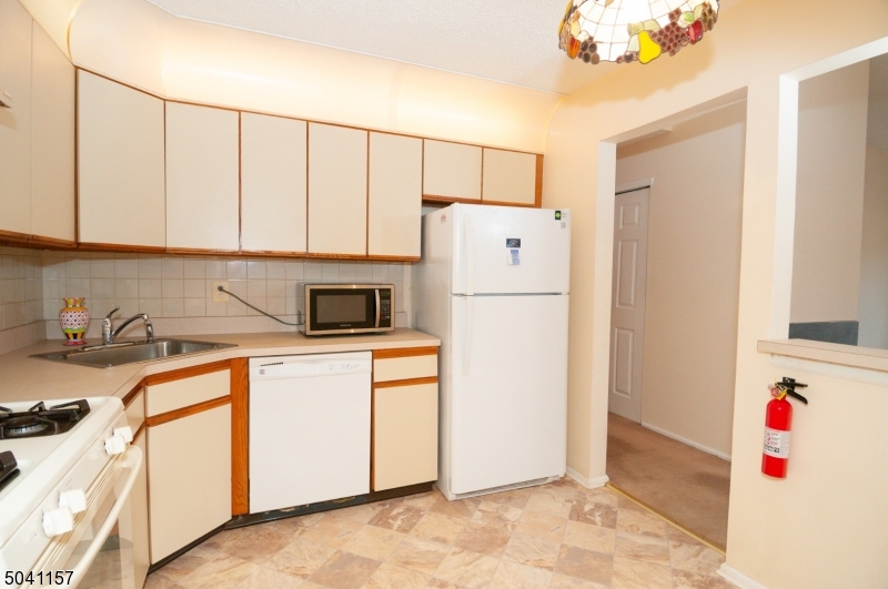 48 Taylor Road Franklin, NJ 07416 - Photo 11 of 25 a kitchen with a refrigerator and a sink