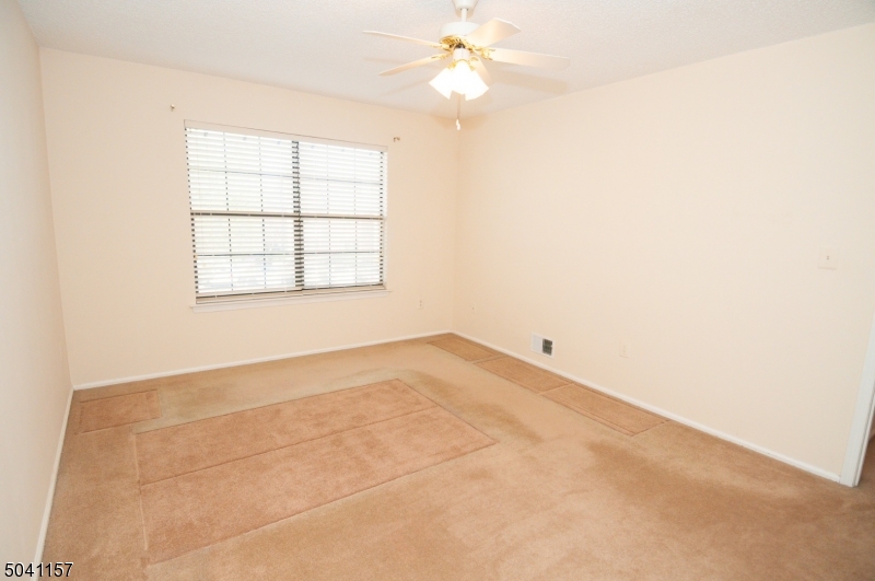 48 Taylor Road Franklin, NJ 07416 - Photo 18 of 25 an empty room with a window and a fan