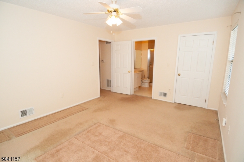 48 Taylor Road Franklin, NJ 07416 - Photo 19 of 25 an empty room with a ceiling fan and a window