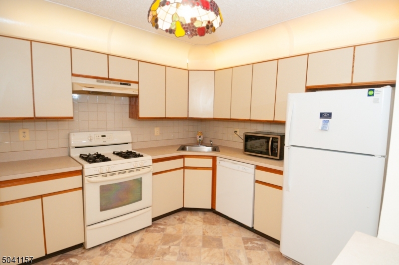 48 Taylor Road Franklin, NJ 07416 - Photo 10 of 25 a white refrigerator freezer sitting inside of a kitchen