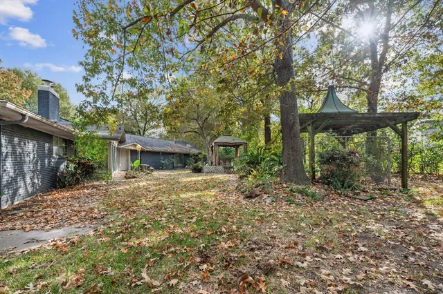 a tree in front of a white house