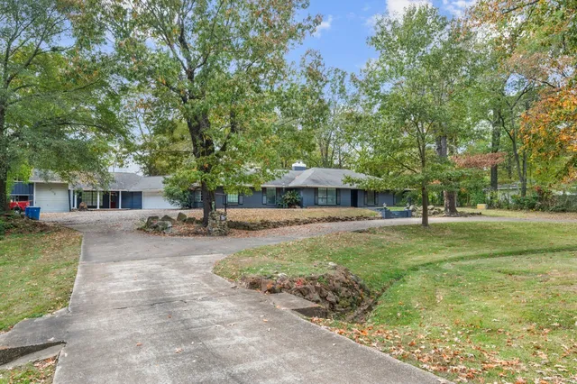 a view of a patio with a table and chairs under an umbrella