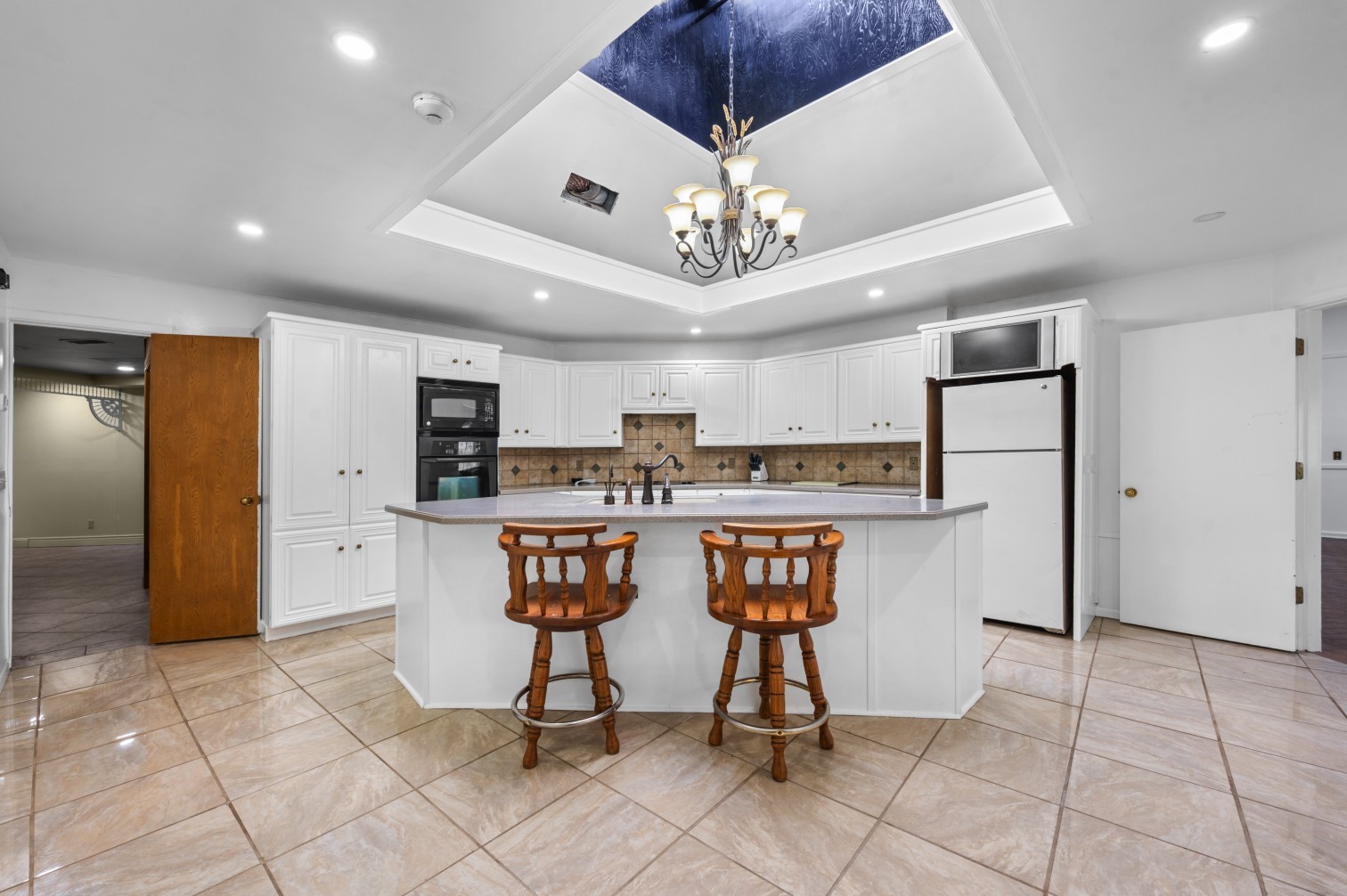 1207 Glade Street Lufkin, TX 75901 - Photo 44 of 49 a view of open kitchen with stainless steel appliances granite countertop a refrigerator and a stove top oven