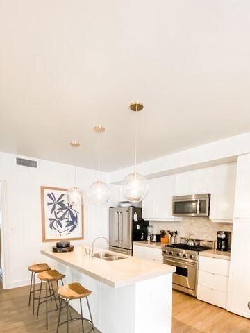 136 Georgetown Avenue, Unit 2C 5 Inlet Beach, FL 32461 - Photo 10 of 18 a living room with stainless steel appliances kitchen island granite countertop a sink and cabinets
