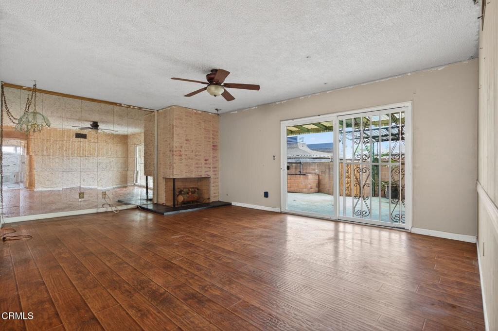 1430 Huntswood Way Oxnard, CA 93030 - Photo 2 of 12 a view of a livingroom with wooden floor a ceiling fan and window