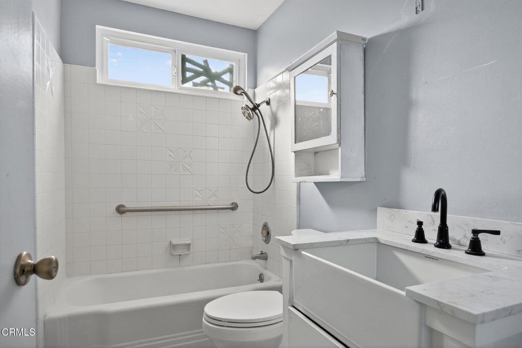 1430 Huntswood Way Oxnard, CA 93030 - Photo 9 of 12 a bathroom with a granite countertop sink a toilet and a bathtub