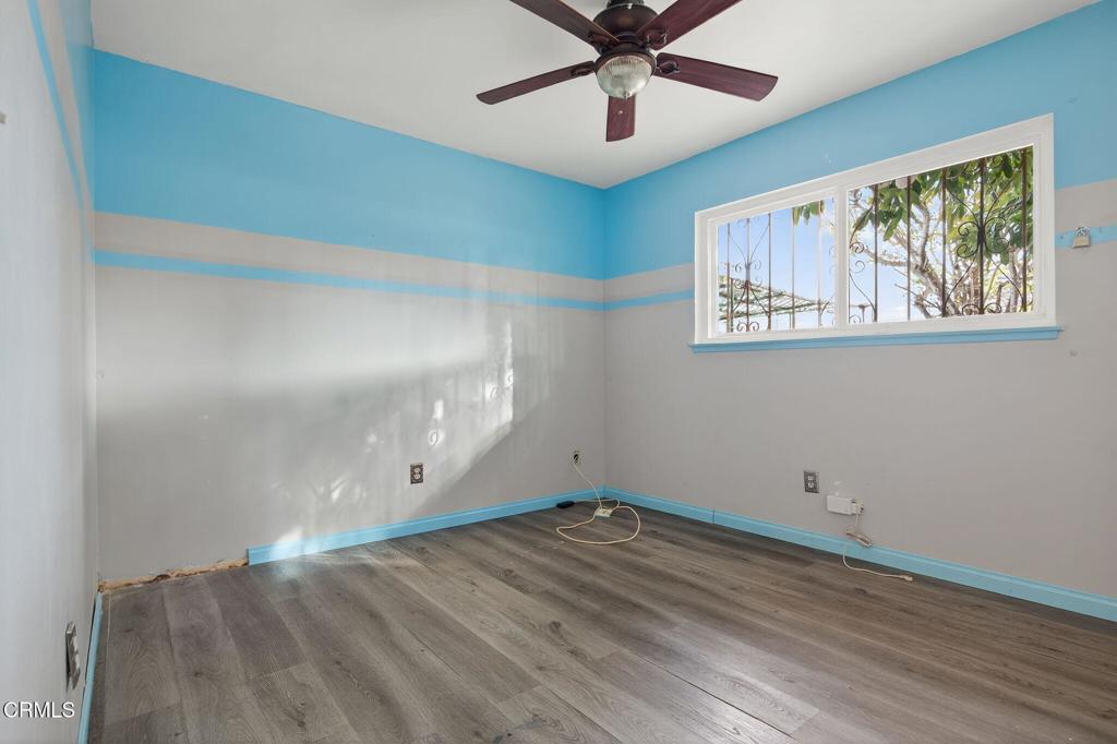 1430 Huntswood Way Oxnard, CA 93030 - Photo 10 of 12 an empty room with wooden floor and windows