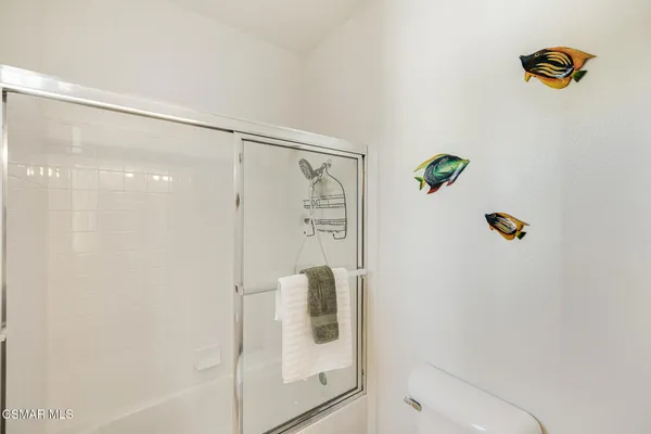 a living room with furniture and a book shelf