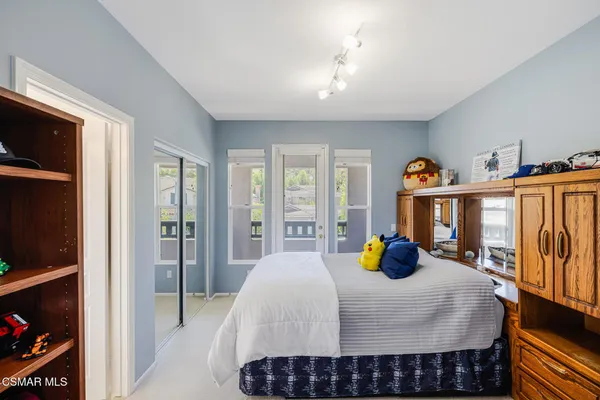 a bedroom with furniture and a wooden floor