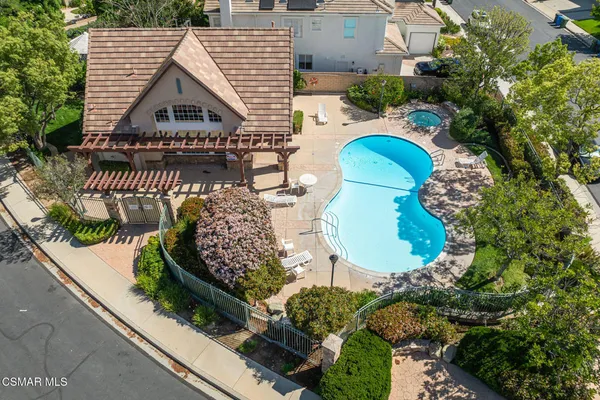 a view of a house with backyard and sitting area