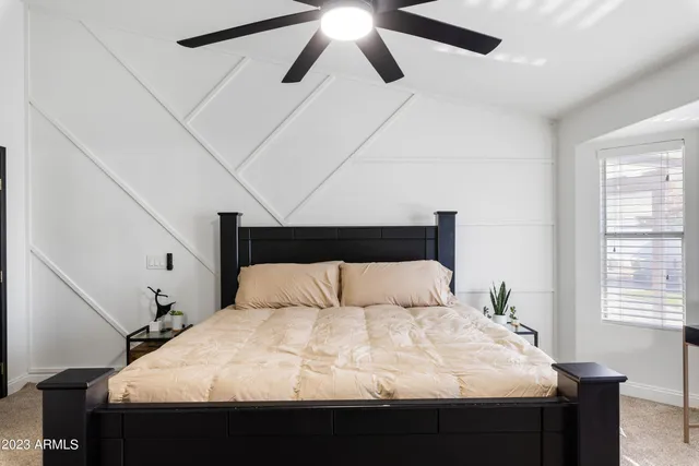 a bedroom with a bed and a window