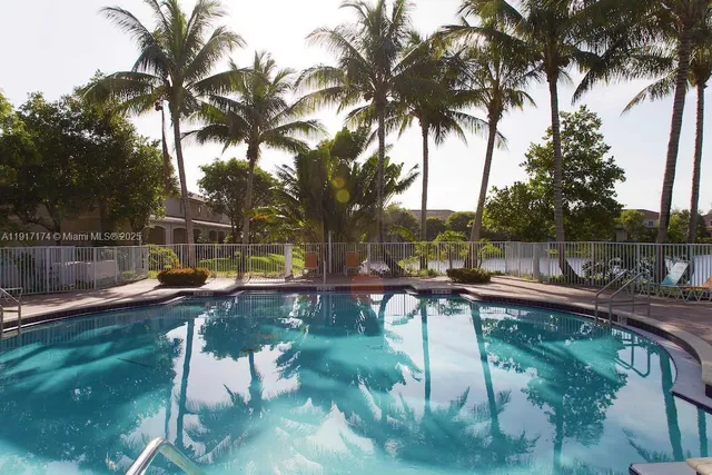 a view of a swimming pool with a patio and a garden