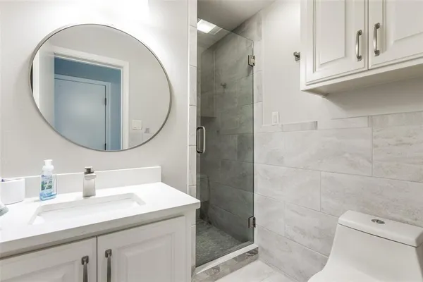 a bathroom with a sink a toilet and a mirror