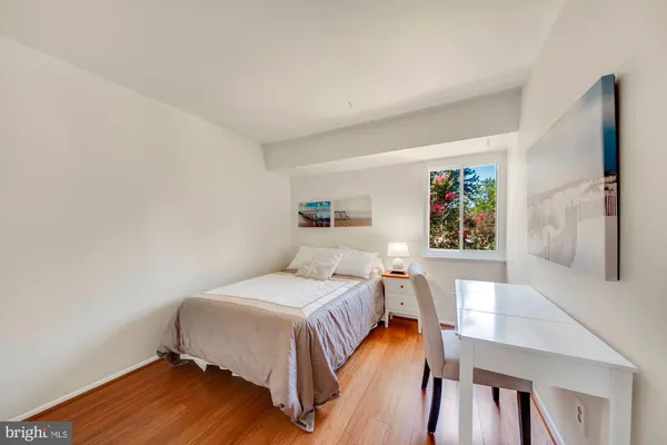 a bedroom with a bed and a table in it