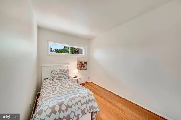 a bedroom with a bed and a night stand