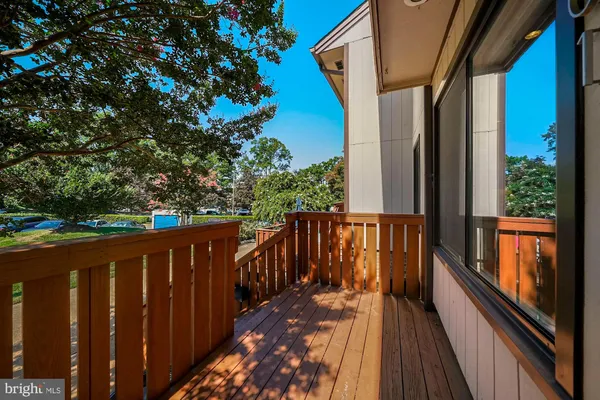 a balcony with wooden floor in front of it