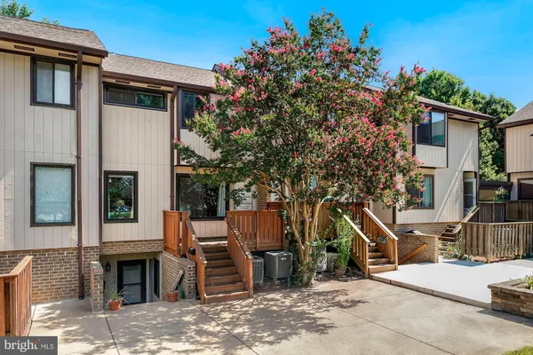 a front view of a house with a tree