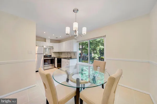 a dining room with furniture and a chandelier