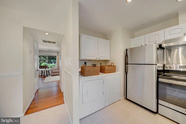 a white refrigerator freezer sitting inside of a kitchen