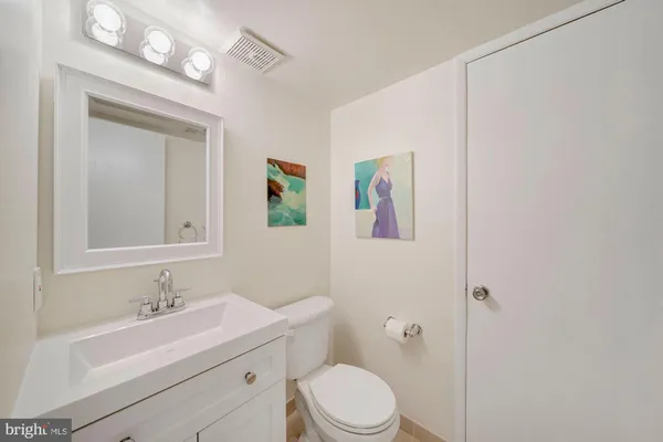 a bathroom with a sink a toilet a mirror and shower