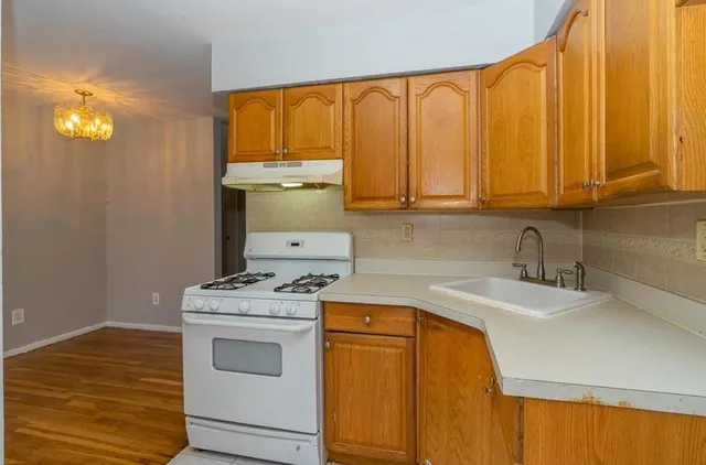 a kitchen with a sink cabinets and appliances
