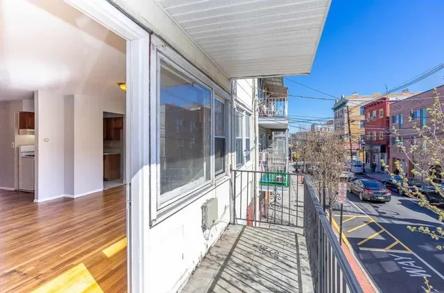 a view of a balcony with wooden floor