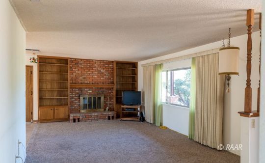 2109 West Ridgecrest Boulevard Ridgecrest, CA 93555 - Photo 11 of 35 a view of an empty room with a fireplace