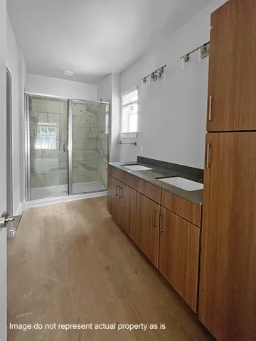 a view of a kitchen with a sink and cabinets